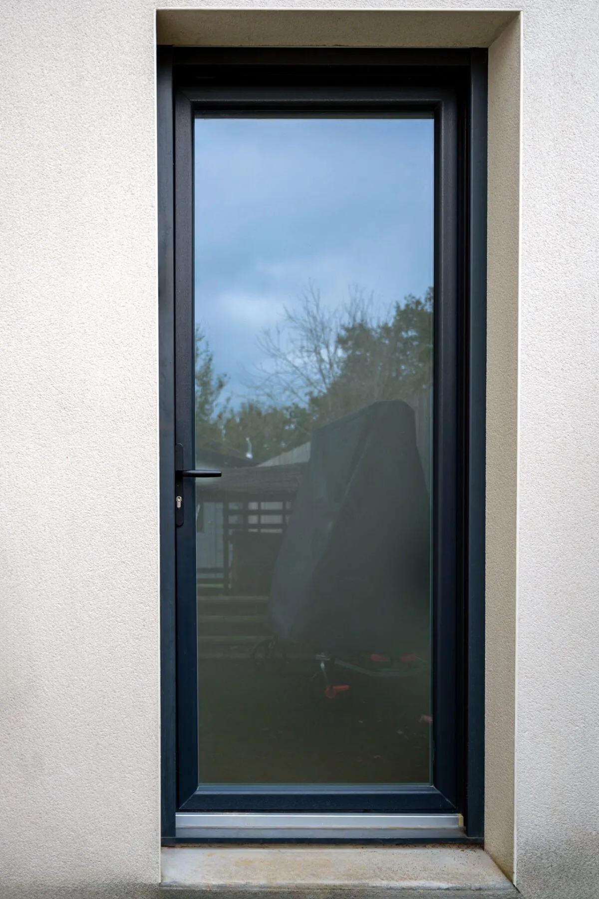 Porte de service en PVC gris anthracite entièrement vitrée, posée par Maison Aubin à Rennes